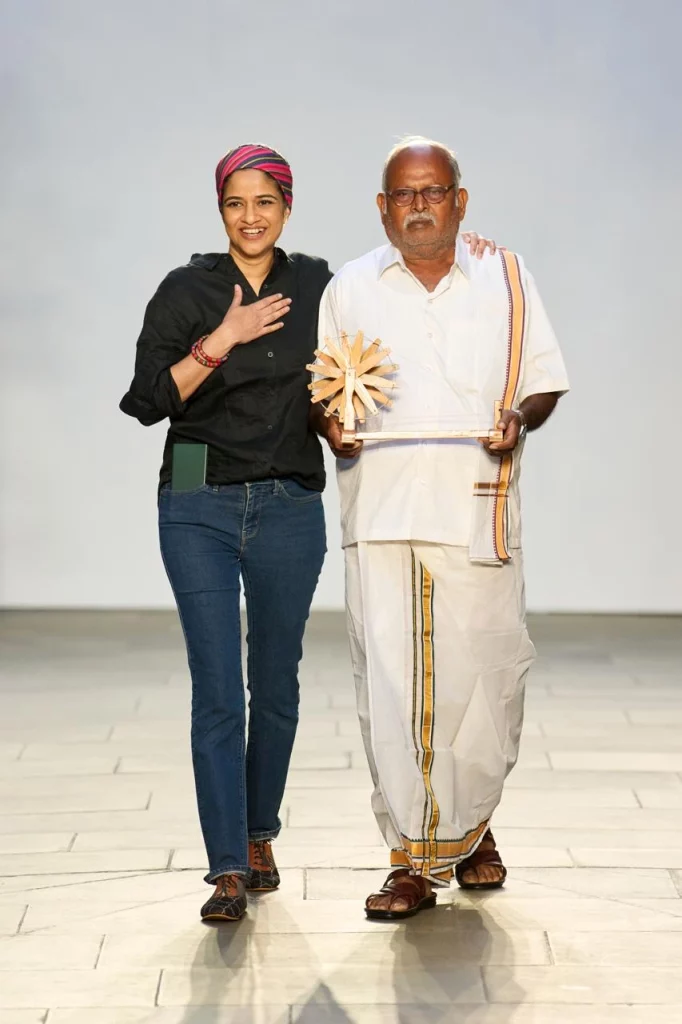Vino Supraja with weaver Sakthivel Periyasamy at the London Fashion Week 